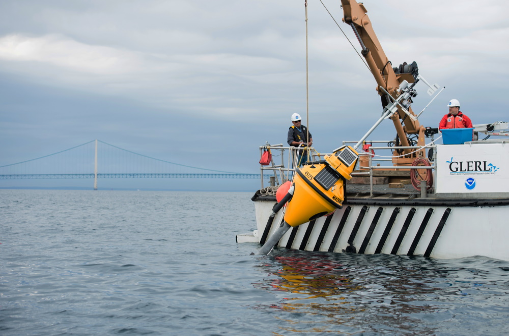 A NOAA GLERL (Great Lakes Environmental Research Lab) buoy equipped with the SeaView Systems SVS-603 wave sensor is shown being deployed at the Straits of Mackinaw, Michigan.